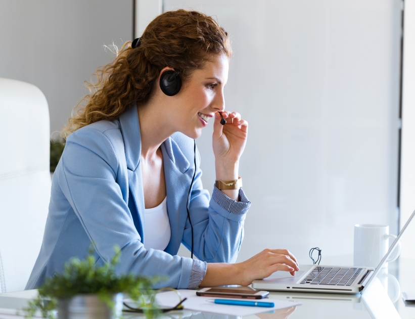 Customer service operator talking on phone in the office.